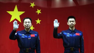 Chinese astronauts Jin Haipeng, left, and Chen Dong, right, wave during a meet the media session at the Jiuquan Satellite Launch Centre in Jiuquan, Gansu province, China. EPA