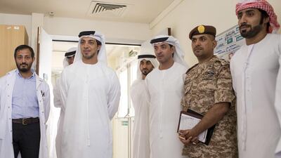 Sheikh Mansour bin Zayed, Deputy Prime Minister and Minister of Presidential Affairs, second left, with Sheikh Hazza bin Zayed, National Security Adviser and Vice Chairman of the Abu Dhabi Executive Council, fourth left, and Sheikh Hamdan bin Mohammed bin Zayed, third left, visit a Armed Forces serviceman.