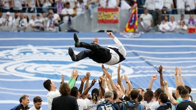 Real Madrid stars throw coach Carlo Ancelotti into the air in celebration after winning La Liga with a 4-0 victory against Espanyol. Reuters