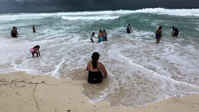 People swim in the turbulent sea at a beach in Cancun, Quintana Roo, Mexico. EPA