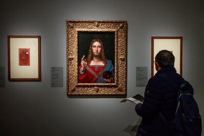 A visitor looks at the painting entitled 'Salvator Mundi' by Italian Renaissance artist Leonardo Da Vinci's workshop during an exhibition at the Louvre Museum in Paris. EPA