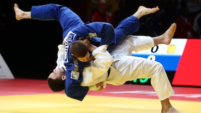 Simeon Catharina of Netherlands, in white, fighting with Hungary's Miklos Cirjenics during the Paris Grand Slam judo tournament on Sunday, February 9. EPA