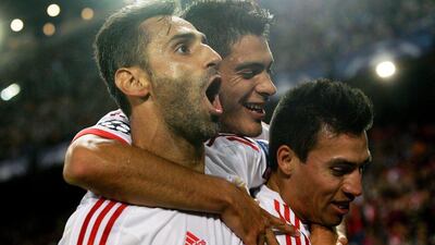 Benfica's Nicolas Gaitan celebrates with teammates after scoring the equaliser in their eventual 2-1 win over Atletico Madrid in the Champions League on Wednesday. Juanjo Martin / EPA / September 30, 2015