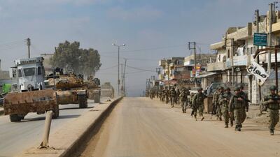 Turkish troops patrol on foot and in military vehicles in the town of Atareb in Syria's Aleppo province on February 19. AFP