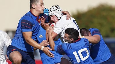 Charlie Capps, centre, of England is tackled by Julien Ruaud, left, and Thomas Darmon, second right, of France during an U18 International Series rugby union match at City Park Stadium in Cape Town, South Africa, 07 August 2015. Nic Botha / EPA