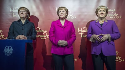 Three wax figures of German chancellor Angela Merkel — front left, dating from 2005, 2009 and 2015 — are on display at the Berlin branch of Madame Tussaud’s wax museum on November 16, 2015, to mark her 10th anniversary in power. John MacDougall / Agence France-Presse