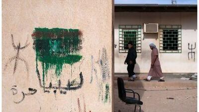 Near the Dehiba border on the Libyan side, pro-rebel graffiti is prevalent, along with the Amazigh symbol, seen here to the left and right of the rebel flag. Lindsay Mackenzie for The National