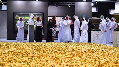 Sheikh Abdullah bin Zayed looks at some of the art on display at Abu Dhabi Art, which include Gu Dexin’s work consisting of thousands of fresh bananas arranged on the floor. Wam