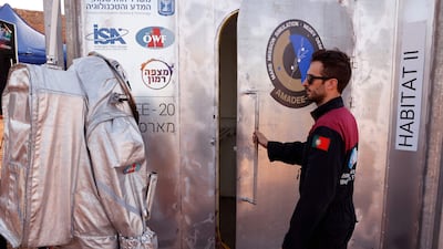 Dressed in a spacesuit, an astronaut prepares to enter the sealed "habitat" that simulates life on Mars. AFP