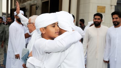 Worshippers greet each other after the Eid prayers. Pawan Singh / The National