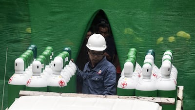 Rescue workers move air tanks at the Tham Luang cave area. AFP