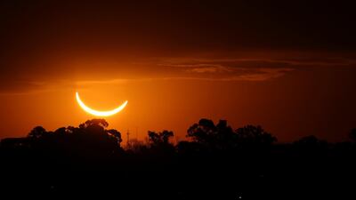 The moon passes in front of the setting sun during a total solar eclipse in Buenos Aires, Argentina. AP Photo