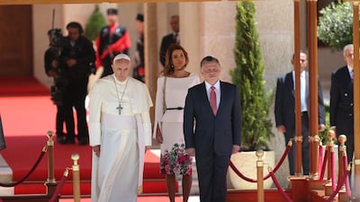 Pope Francis is welcomed by King Abdullah II and Queen Rania at the royal palace in Amman, Jordan in May 2014. Getty Images