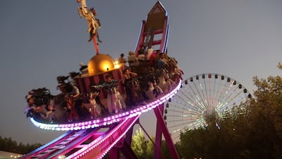 Fairgoers take a ride as they celebrate Eid Al Adha in Iraq's capital Baghdad. Reuters