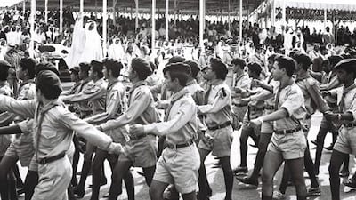 Sheikh Zayed at the 1st anniversary of National Day celebration on December 2, 1972, waving as a scout parade takes place.