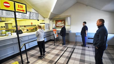 Residents socially distance while waiting to be served at Gullivers Fish and Chip shop in Bradford. Getty Images