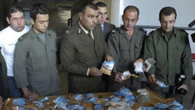 Lebanese customs officers display confiscated drugs of Captagon pills found in a bus, at Beirut Port, in Lebanon, on Nov 26 2007.