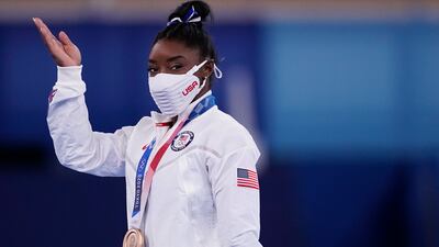 Simone Biles, of the United States, reacts after winning the bronze medal.
