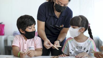An OliOli instructor guides children through the summer camp. Chris Whiteoak / The National