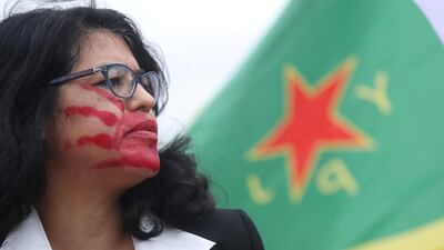 Protesters rally to object to US President Donald Trump's decision to withdraw troops from northeastern Syria in front of the White House in Washington. Reuters