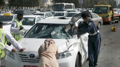 Police clean up the scene of an accident, involving multiple cars at the corner of 15th Street and Airport Road in Abu Dhabi.