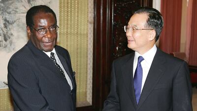 Chinese Premier Wen Jiabao geets Zimbabwe President Robert Mugabe on July 27, 2005 in Beijing, China. Getty Images