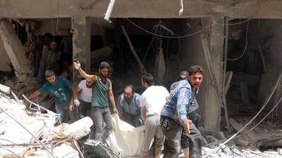 Syrians carry a body following a reported regime air strike on the rebel-held neighbourhood of Sukkari in the northern city of Aleppo on June 3, 2016. Thaer Mohammed/AFP