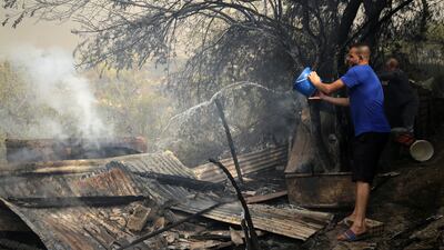 A man tries to extinguish a fire in the village of Zberber, Bouira province in the Kabyle region, Algeria. EPA