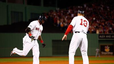 David Ortiz (left) rounds third base after hitting the second of his two home runs Saturday. Jared Wickerham / Getty Images/ AFP