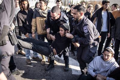 Israeli police officers try to move protesters as they block roads during a protest against the ceasefire agreement with Hamas in Jerusalem on Thursday. AFP