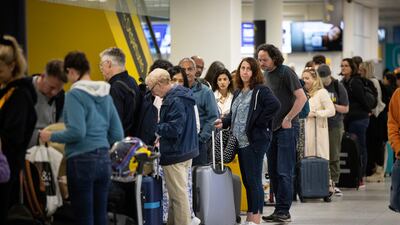 Travellers queue to check in for their flights at Gatwick. EPA
