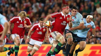 Jamie Heaslip, of the Lions, runs the ball. He proves too quick for his opponents. Cameron Spencer / Getty Images