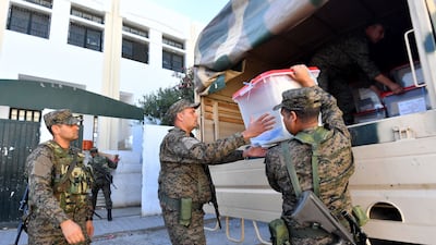 Tunisian soldiers deliver ballot boxes to a polling station in Ariana, near Tunis, on Saturday. AFP