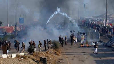 Protesters hurls back a tear-gas shell fired by police during clashes in Islamabad, Pakistan, on November 25, 2017. Anjum Naveed / AP Photo