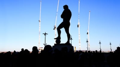 A silhouette of the Bobby Moore statue in London with construction cranes in the backdrop - Britain’s services sectors, making up the biggest part of the economy, saw growth improve in February. Catherine Ivill / Getty Images)