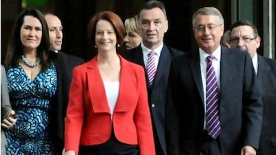 Australian Prime Minister Julia Gillard, centre, arrives with supporters for the caucus meeting in Parliament House in Canberra. Ms Gillard survived a leadership challenge from Kevin Rudd, trouncing the former leader in a damaging battle to head the ruling Labor party.