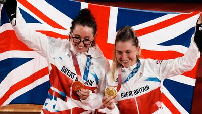 Gold medalist Katie Archibald, left, and Laura Kenny of Team Britain celebrate during a medal ceremony for the track cycling women's madison race.