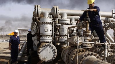 Opec has been through several periods of supply-demand imbalance and wild markets since 1973. Above, workers at an oil field in Iraq. Nabil Al Jurani / AP Photo
