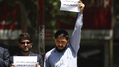 Afghan journalists hold placards reading in Dari that read, 'Stop deceiving - Journalists are not something to play with', during a protest boycotting an ongoing official conference marking International Day of Media in Kabul, Afghanistan 03 May 2018. Jawad Jalali / EPA