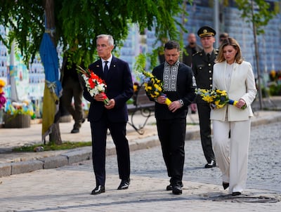 Canada's Prime Minister Mark Carney joins Ukrainian President Volodymyr Zelenskyy and his wife, Olena Zelenska, at a wreath-laying ceremony at the memorial wall, in Kyiv. AP