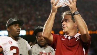 Alabama Crimson Tide's head coach Nick Saban holds up The Coaches Trophy after they defeated the Notre Dame Fighting Irish.
