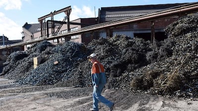 A worker walks past metal shavings in the scrap yard of Sheffield Forgemasters. Oli Scarff / AFP