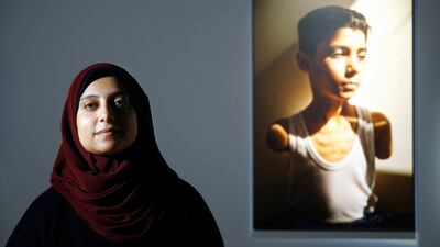 Palestinian Samar Abu Elouf, winner of the 2025 World Press Photo of the Year, with her winning photograph in Barcelona. EPA