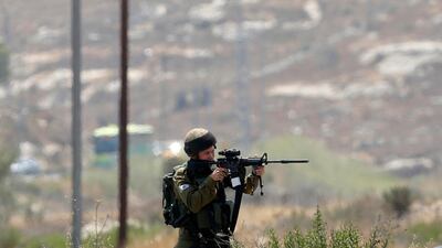 An Israeli soldier takes aim during clashes in the West Bank city of Ramallah on July 24, 2017. Nasser Shiyoukhi / AP