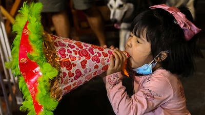A child blows a trumpet at Eastwood Mall in Quezon City, Philippines. Reuters