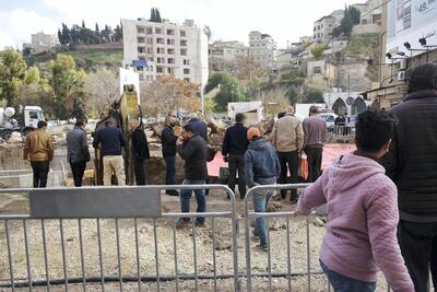 Passersby observe an archaeological Roman site, uncovered during sewage works in Amman, Jordan. Amy McConaghy / The National