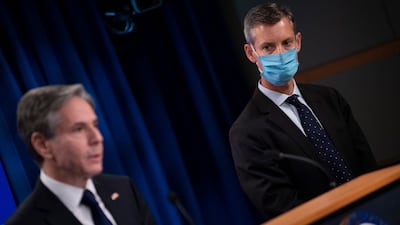 State Department spokesperson Ned Price stands on the side of US Secretary of State Antony Blinken. AFP