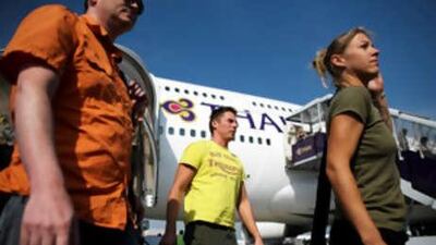 Passengers leave a Thai Airways flight from Phuket, at Suvarnabhumi International Airport on Dec 3 2008 in Bangkok, Thailand.