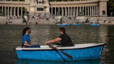 People sail a boat at the Retiro park in Madrid, Spain. AP Photo