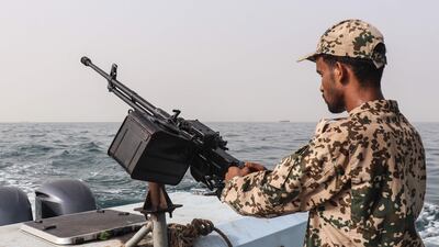 A sailor working for Yemen's internationally recognised government at a machinegun position during a patrol of the Red Sea. AFP